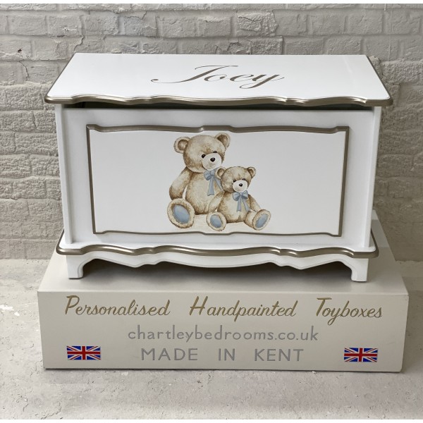 Two Bears With Blue Bows On Toy Box With Name